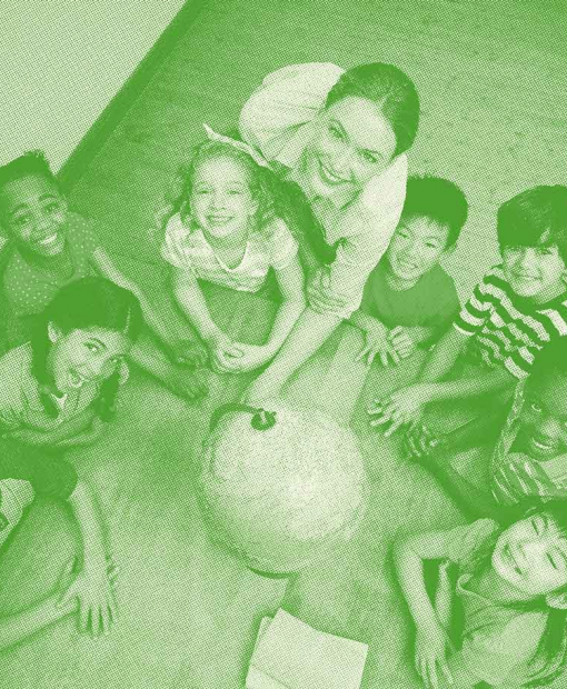 Group of children in front of a globe to represent Dalkia’s commitment for the preservation of natural resources